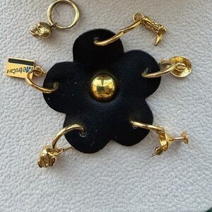 Gold plated Huggies metro card, cowboy boot, skull, cowboy hat and martini